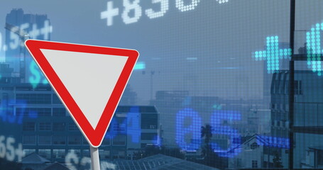 Image of financial data processing over triangle road sign and city