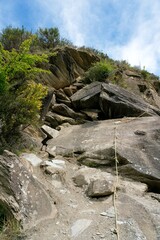 Climbing Rope with Knots on a Rugged Rock Formation