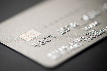 Macro low key credit card or debit card background with selective focus on microchip