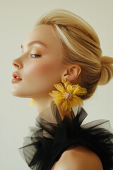  close-up of a person with short, light blonde hair, wearing large, intricate floral earrings