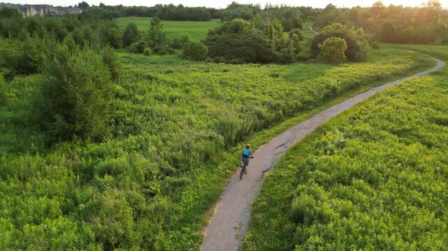 Aerial view of a mountain biker on a path at sunset - Vue a&eacute;rienne d'un v&eacute;t&eacute;tiste sur un chemin au coucher de soleil