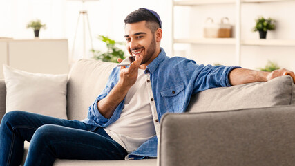 Phone Call, Mobile Communication And Voice Assistant Concept. Smiling Bearded Man In Kipa Talking...