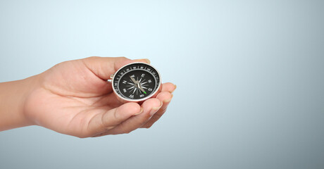 Hand holding compass symbolizing direction and navigation in an urban setting Business Concepts, Business Approaches and Success in Finance, Banking and Investment