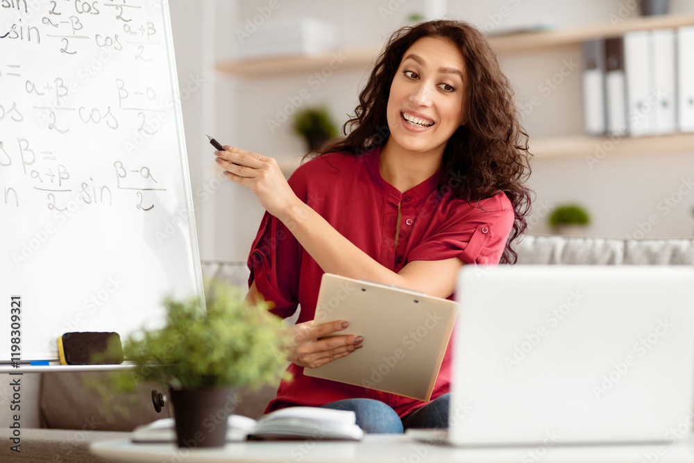 Poster young professional tutor recording video tutorial for her blog using and looking at laptop screen, p