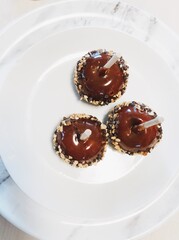 Caramel apples on a white plate for Halloween