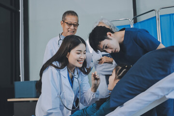 Fototapeta premium A team of doctors and nurses are working to treat a female patient in the patient's room.