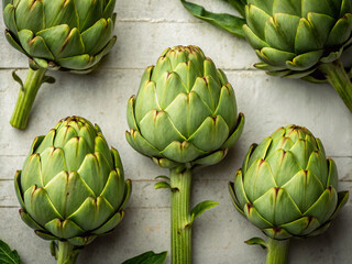 Fototapeta premium artichokes on a wooden table. artichoke, food, vegetable, green, healthy, fresh, isolated, artichokes, organic, plant, diet, white, raw, vegetarian, vegetables, flower, market, cook, eat, nutrition, a