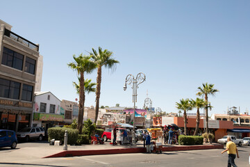Heroica Nogales, Sonora, Mexico - May 29, 2022: Pedestrian traffic passes in the graffitied downtown center of Nogales.