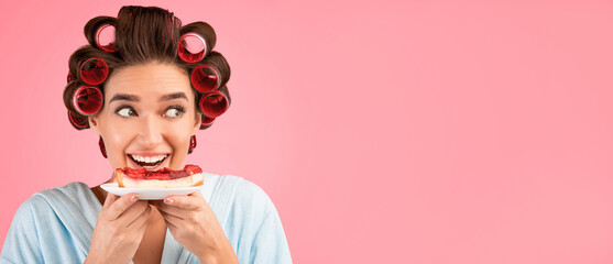 Cheat Meal. Hungry Girl With Curlers Eating Cake Enjoying Sweet Dessert Posing On Yellow Studio Background. Empty Space