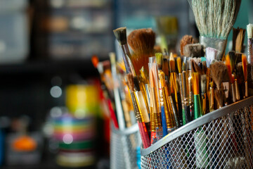 Fototapeta premium Vibrant collection of artist brushes in a studio setting – tools of creativity.
