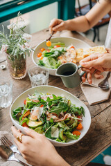 Cropped hands of woman having food at table