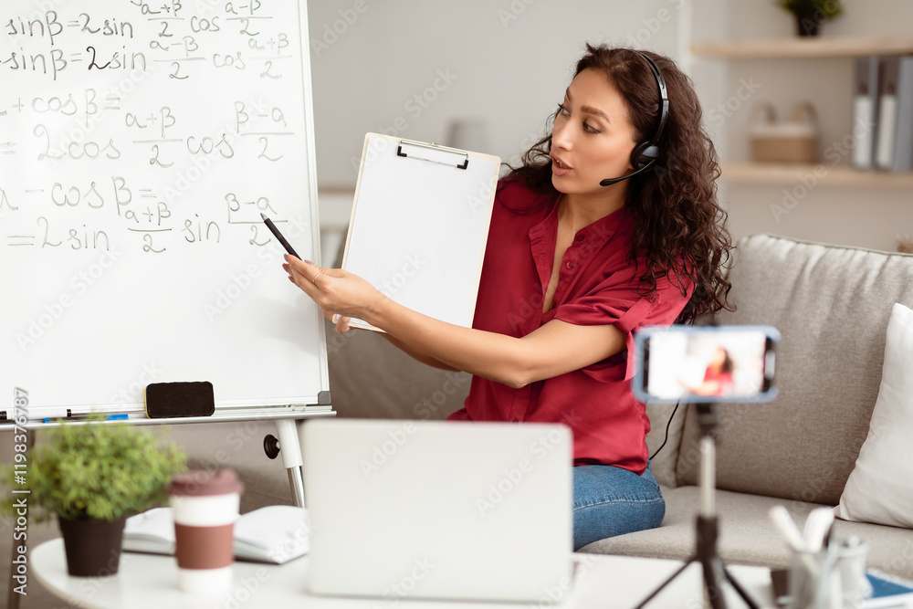 Poster e-learning. confident woman having video conference call using laptop. lady teacher in headset showi