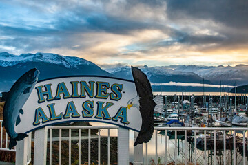USA, Alaska, Haines. Sign and moored boats in marina.