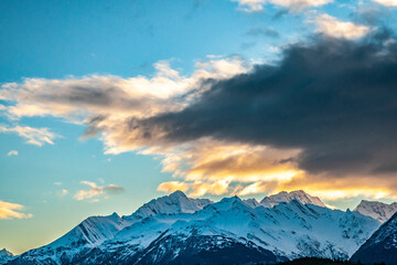 USA, Alaska, Chilkat River Valley. Mountain landscape and clouds at sunset.