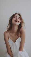 Naklejka premium 57. A playful girl with a wide grin, wearing a white dress, against a clean white backdrop