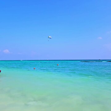 Parachute glider above the calm Caribbean Sea. Location: Maya Riviera, Mexico