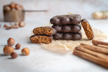 Vintage-style display featuring hazelnuts, spices, and chocolate-covered gingerbread cookies. Ideal for bakery ads, confectionery packaging, or dessert-themed social media content.