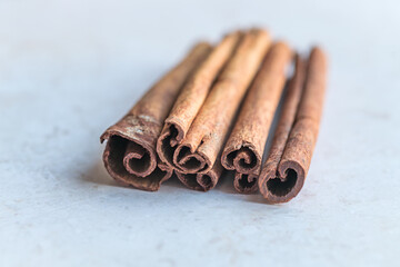 Detailed shot of rolled cinnamon bark sticks. Suitable for use in recipe websites, food blogs, or baking tutorials highlighting the use of aromatic spices.