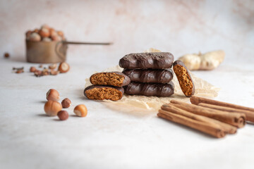 Rustic setup with a vintage pot of hazelnuts, cinnamon sticks, and chocolate-covered gingerbread cookies. Perfect for festive campaigns, holiday recipe ideas, or seasonal promotions.