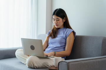 Naklejka premium Happy beautiful Asian Woman. Business woman working from home with laptop Financial Home work space concept.