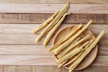 Soy bean curd sticks on wood background