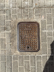 An iron water access cover marked 