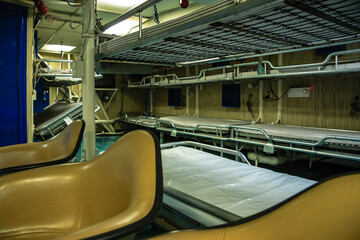 A hospital room with beds and a chair
