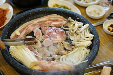 불판 위에서 삼겹살을 맛있게 굽고 있는 모습