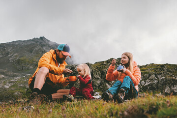Family on picnic in mountains camping travel - father, mother and child eating hiking food, parents and kid having lunch outdoor together active adventure vacations backcountry kitchen