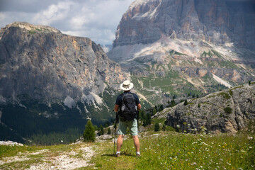Man traveler traveling alone in breathtaking landscape of Dolomites Mounatains.