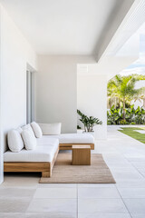 Fototapeta premium Modern outdoor lounge area with minimalist design and lush greenery in sunny setting
