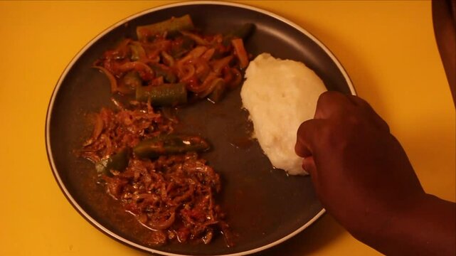 Matemba or Kapenta Fish (Limnothrissa miodon, Lake Tanganyika Sardine) and Okra Stew served with corn meal pap