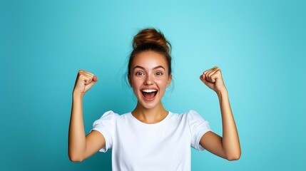 Woman celebrates joyfully with raised fists against a bright blue background