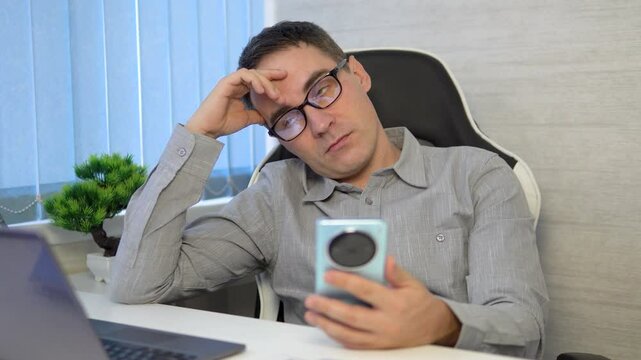 Freelancer Burnout. Tired Man Feeling Sleepy At Workplace In Home Office, Young Male Exhausted After Working Online On Laptop Computer, Having Problems With Remote Job,