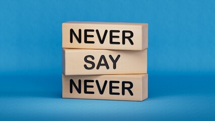 Never say Never symbol. Concept words Never say Never on wooden blocks.Business concept. Wooden cube blocks. Copy space.3D rendering on blue background.