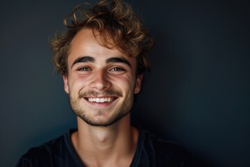 Obraz premium Handsome smiling young man studio portrait