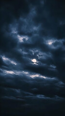 Obraz premium Dark Clouds Obscure the Moon in a Moody Night Sky Photograph