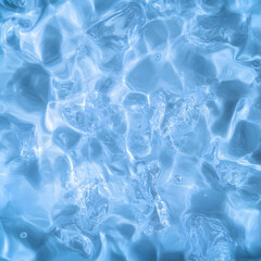 Naklejka premium Close-up water surface with ripples and bubbles creates a dynamic abstract blue texture background.
