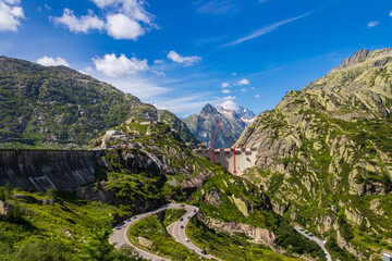 Scenic view of construction site with red cranes of new dam at Swiss mountain pass Grimsel