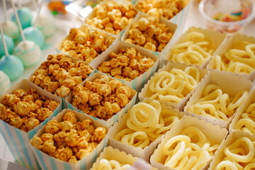Caramel popcorn cups and chip rings for a festive dessert. A simple and delicious candy bar for a party.