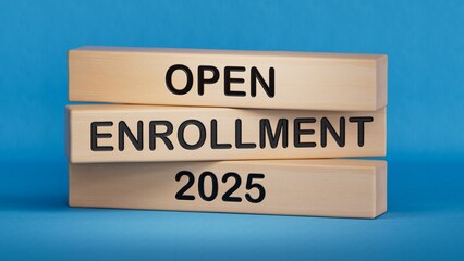The word OPEN ENROLLMENT 2025 written on Wooden blocks. Wooden cube blocks. Copy space.3D rendering on blue background.