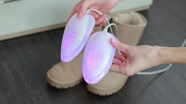 A pair of winter shoes with an electric shoe dryer with UV sterilization. Shoe care devices.