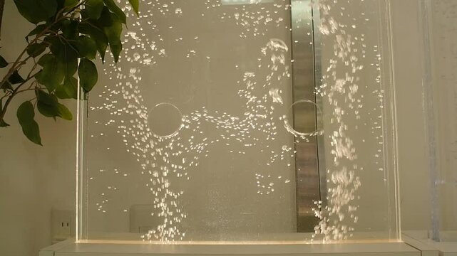 Air bubbles circulate inside the water that flows within an acrylic panel. This sustainable maintenance-free technology heals many people's hearts and mentality, and functions as partition.