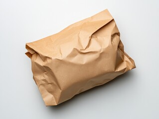 Fototapeta premium crumpled brown paper bag for packaging on white background