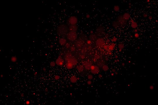 Abstract red particles on a black background, creating a vibrant and dynamic visual effect.