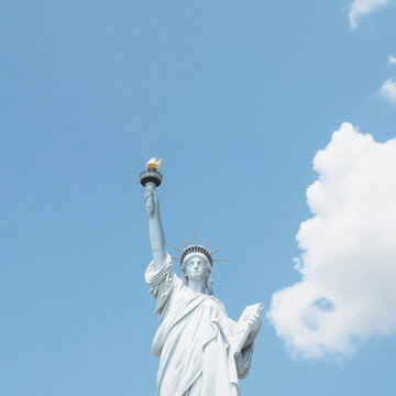 A statue of a woman holding a torch in her right hand