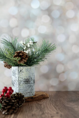 Winter floral arrangement with pine cones and holly berries