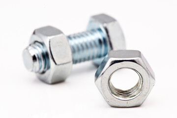 Close up of a metal bolt and nut showcasing industrial fasteners and their design