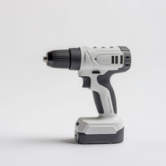 A white and black power drill is sitting on a white surface