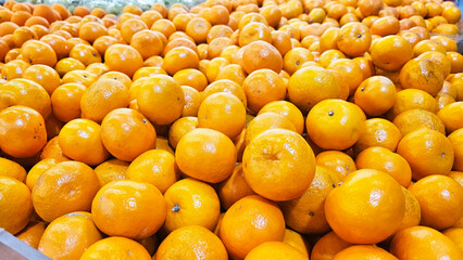 Orange Abundance: A vibrant and plentiful pile of fresh, juicy oranges, their bright color radiating energy and freshness.  